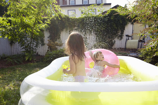 Girls having fun in inflatable pool