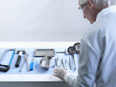 Pathologist preparing for autopsy