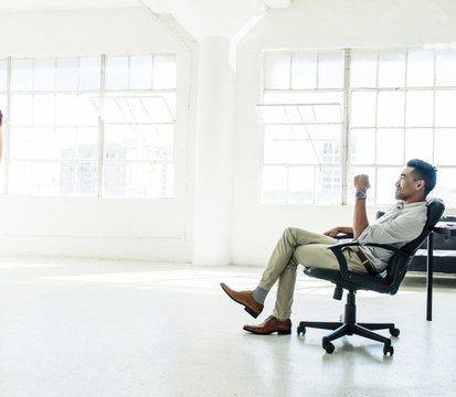 Businessman sitting on chair and thinking in the office