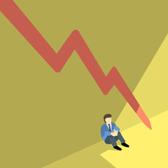 business man sitting alone against shadow wall with red arrow pointing downwards.