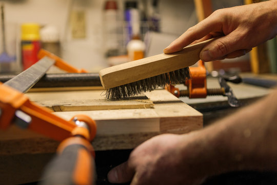 Wood artist working in workshop, close-up