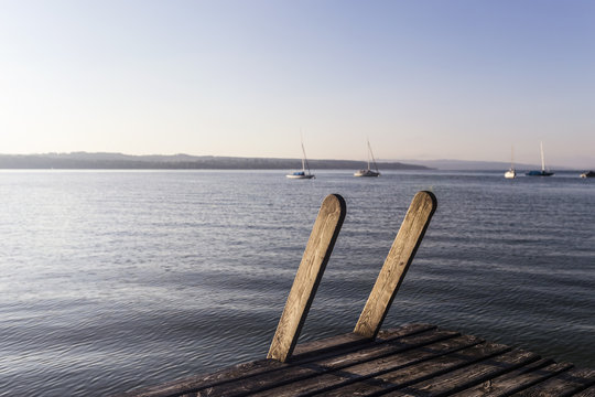 View of lake from wooden pier, Schondorf, Ammersee, Bavaria, Germany