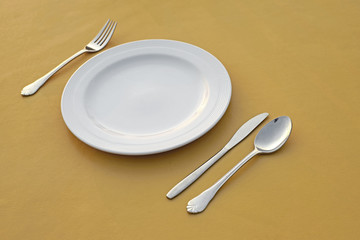 spoon fork  knife and empty white plate