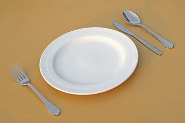 spoon fork  knife and empty white plate