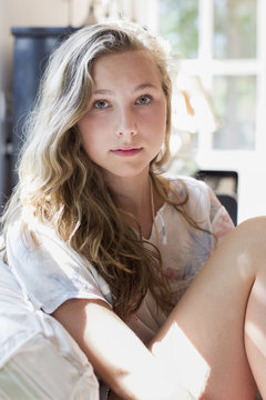 Portrait of pretty teenage girl on sofa