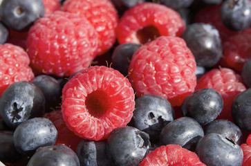 Dessert, fresh berries close-up. The texture of berries, raspberries and blue-berries, macro shot. 