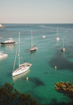 Yachts anchored in bay at Cala Macarella, Menorca, Spain