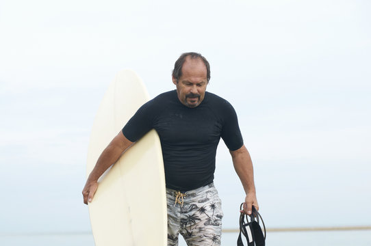 Surfer carrying surfboard