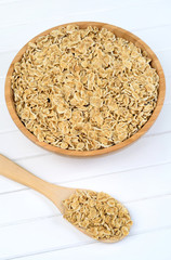 Oat flakes in bamboo bowl