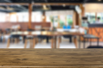 Selected focus empty brown wooden table and Coffee shop blur bac