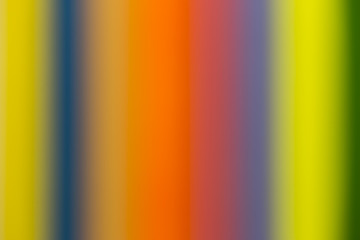 a number of colored pencils , blurred background