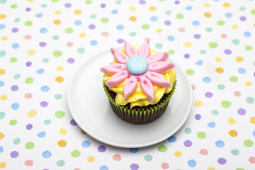 close-up shot of a cupcake with floral pattern in plate.