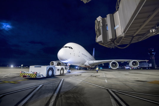 Chief engineer with A380 aircraft on runway at night