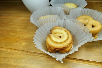 Butter cookies on a wood background.