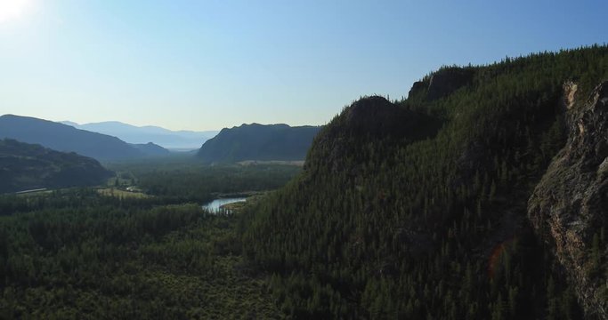 Aerial Shot of open rangeland with forest and mountains. Altai, Siberia. Kurai Steppe.