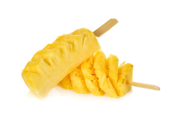 sliced small pineapple with wooden skewer on white background