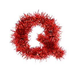 Tinsel Christmas decoration in form of Q. On a white background