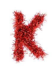 Naklejka premium Tinsel Christmas decoration in form of K. On a white background