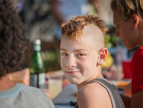 Portrait of boy with mohawk, smiling