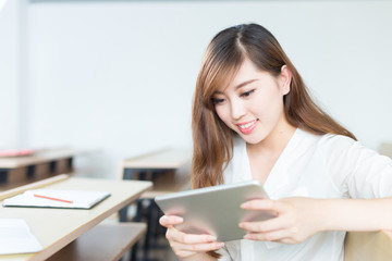 young beautiful asian girl student in classroom