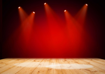 Red stage light on wooden floor background