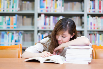 young beautiful asian girl in school library