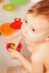 Fototapeta na wymiar Beautiful baby girl playing with water in the bath