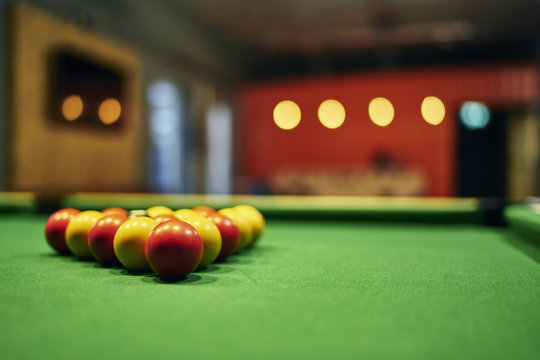 Close up of yellow and red pool balls on pool table