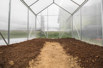View into an Empty Small Greenhouse Ready for Spring Vegetable P