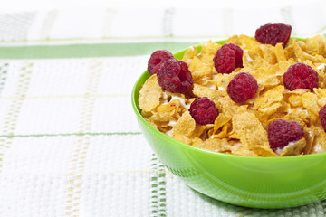 a bowl with cereals and raspberries