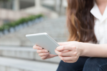 young beautiful asian girl with tablet in school