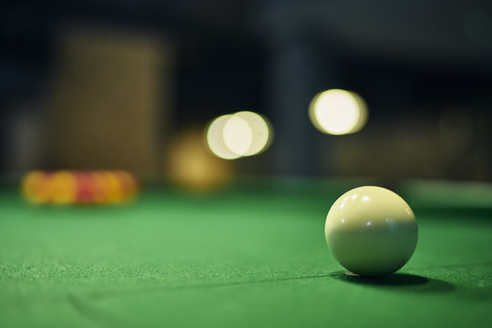 Close up of white cue ball on pool table