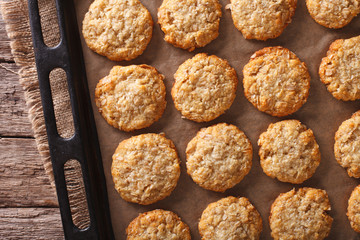 Tasty oatmeal cookies close-up on a baking sheet on the table. horizontal top view
