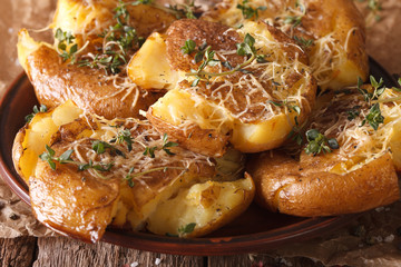 Australian food: crash hot potatoes with thyme on a plate close-up. horizontal
