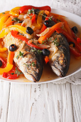 Mackerel in vegetable marinade close-up on the table. vertical
