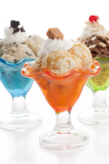 three cups of ice cream in different flavors