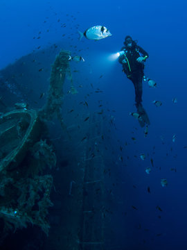 Full length front underwater view of diver investigating MS Zenobia shipwreck, Larnaca, Cyprus