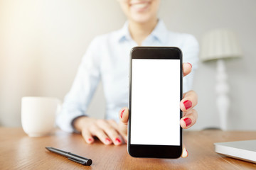 Cropped portrait of female freelancer chatting on cell phone while having coffee in cozy caf?. Close up view of woman's hands showing smart phone with copy space for your test or information content