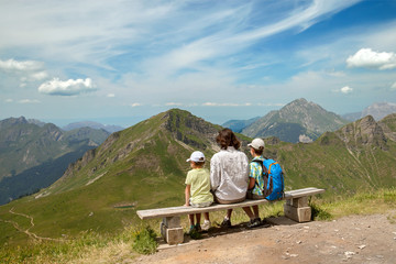 Fototapeta na wymiar father with children admire the mountain scenery