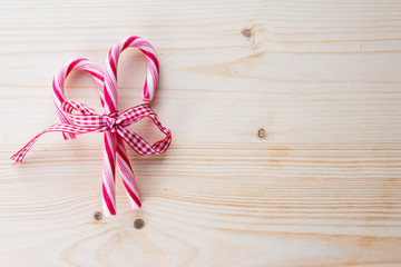 Christmas background, pink christmas candy on wooden background