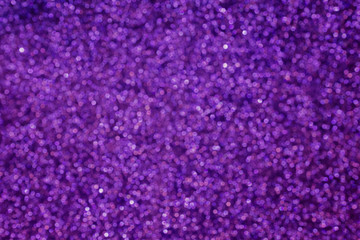 Small bokeh light sparkle shining on violet purple background fo