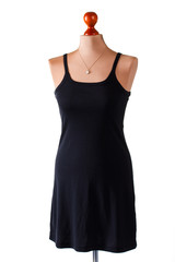 Casual black dress and necklace. Dress and necklace on mannequin. Lady's plain clothes and accessory. Simple and stylish.