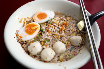 Pork ball and minced pork Noodle tom Yum with boiled eggs thailand Style

