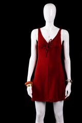 Short dress with keyhole neckline. Mannequin wearing short red dress. Lady's brand new evening apparel. Attractive clothing on sale.