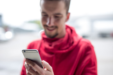 Happy man using smartphone.