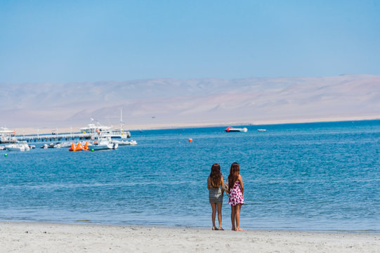 Sweer Lonely girl stand on the beach with dessert moutain view,