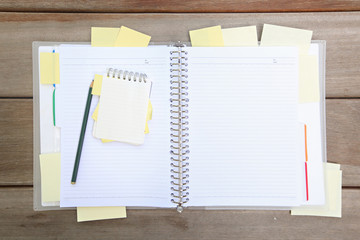 Notebook with pen and sticky notes with space for text