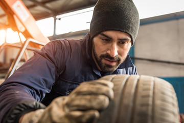 Mechanic, checking a measurement gauge to check the depth of a t