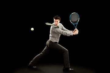 Fototapeta na wymiar sport businessman plays tennis on black background