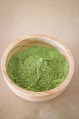 Premium green tea powder in wooden bowl